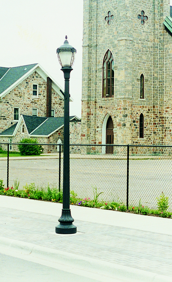 Grosse Pointe 3173BP-BLK-CTP post top lighting fixture in front of a church.