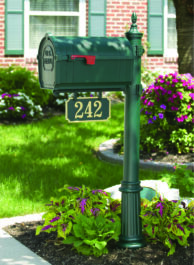 A green colored mailbox with an address plate below.